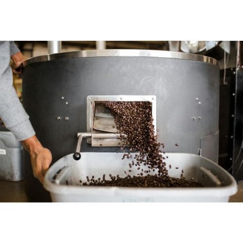 Black Crown Coffee Co. small batch roasting with coffee being extracted from large roaster